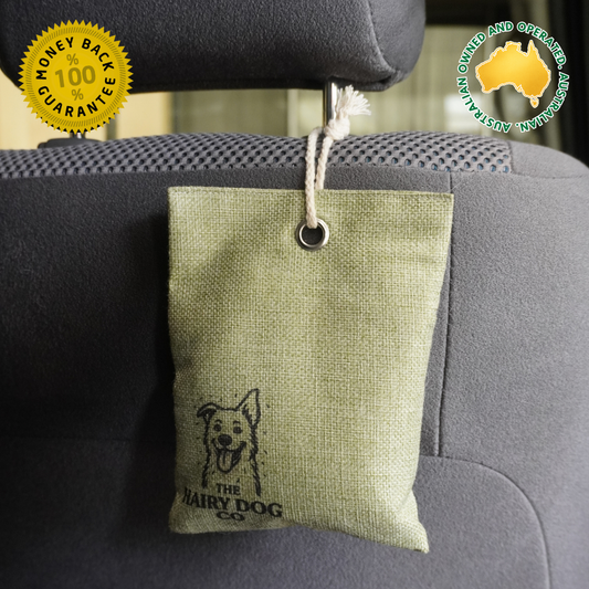 Green Activated charcoal moisture absorber hanging from car headrest to remove wet dog smells and moisture, Australian owned and operated.